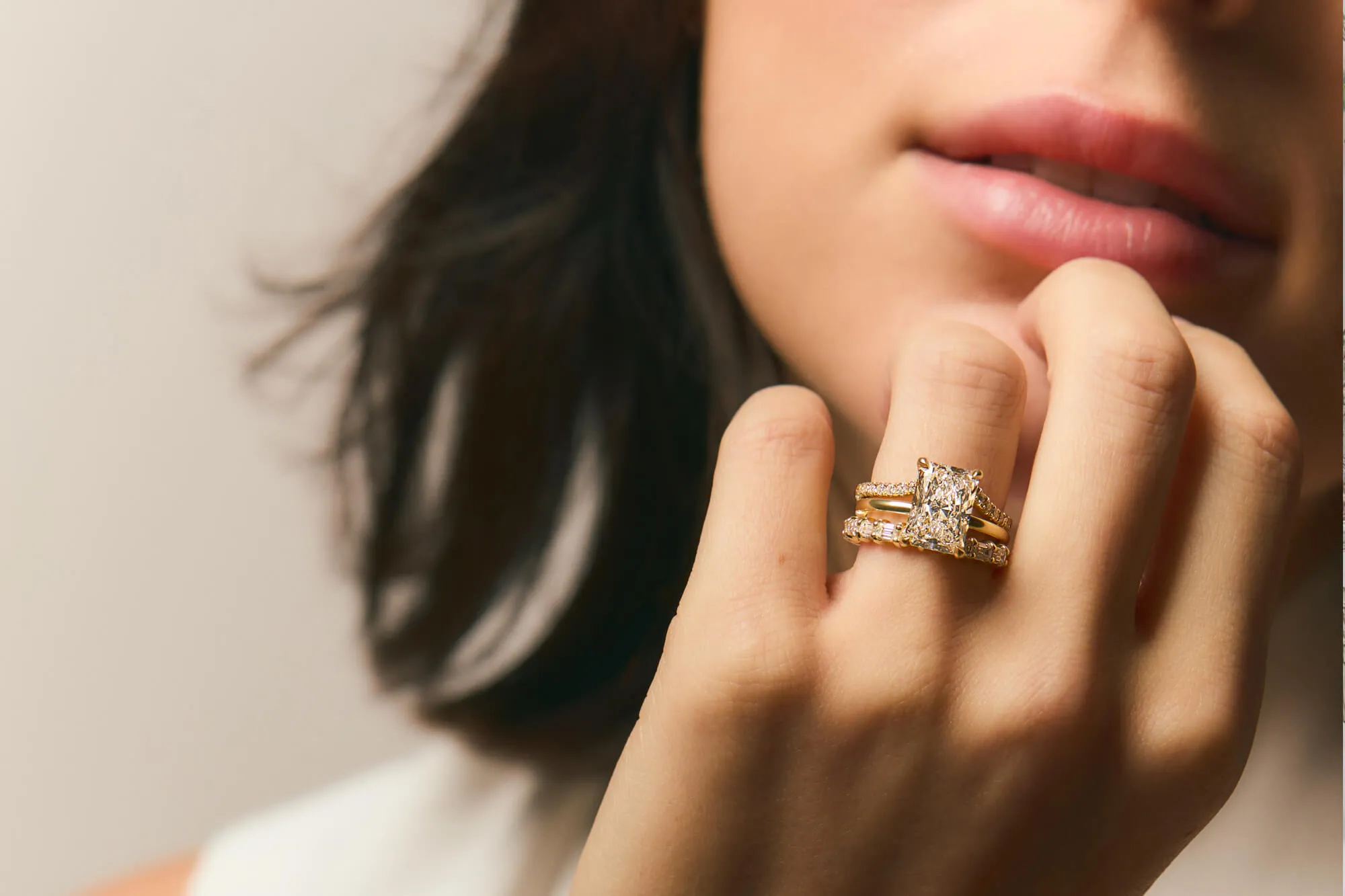 Close-up of a woman's hand wearing two beautiful Plum Diamonds rings.